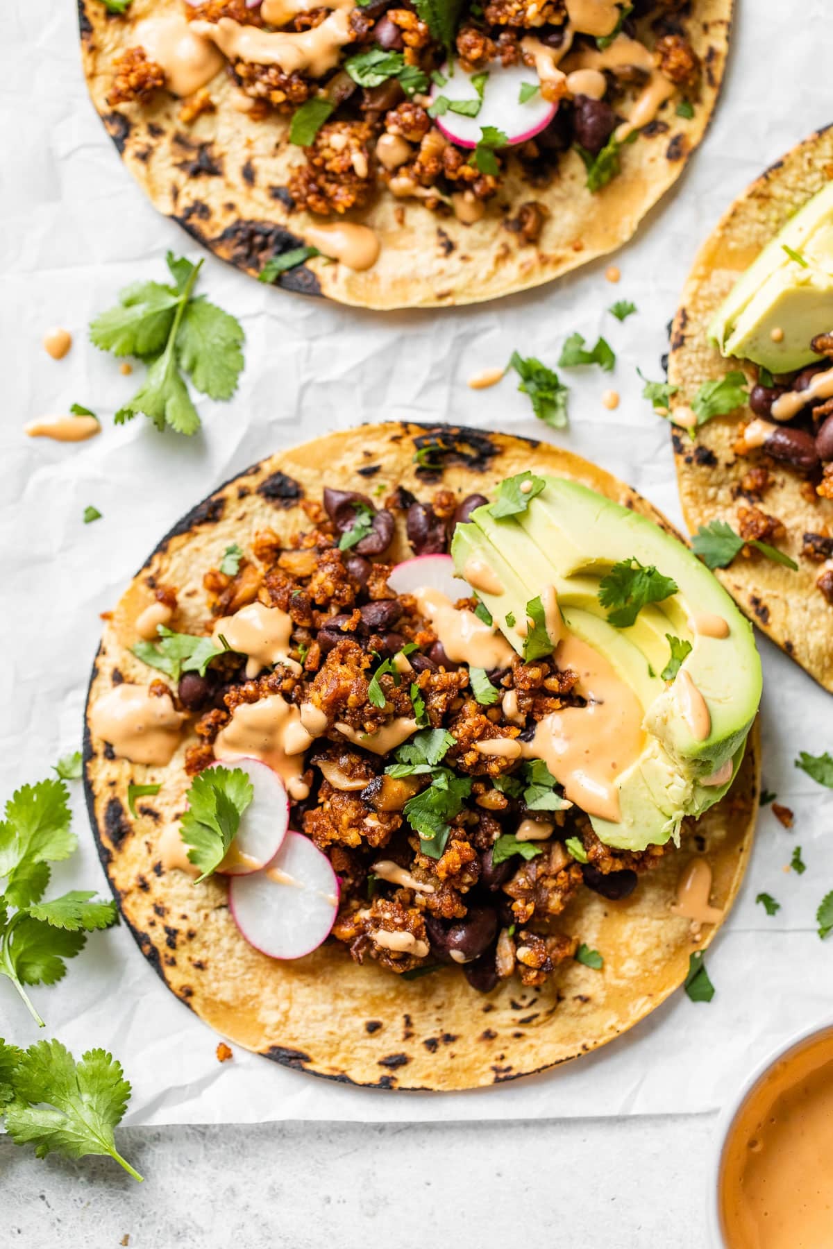 close up of a taco on parchment paper with cilantro
